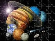 Planets Jigsaw free online puzzle game screen showing shuffled pieces of a beautiful image of the solar system and planets