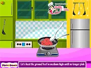 Screenshot of the Easy Baked Ravioli cooking game showing a casserole dish layered with pasta, meat, sauce, and cheese ready to be baked.
