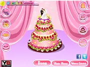Playing Wedding Cake Challenge online game, decorating a multi-tiered cake with frosting and toppings to match the sample.