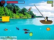 Screenshot of Fishing Penguin free online game showing the penguin fishing for colorful fish and trying to avoid a bone fish.
