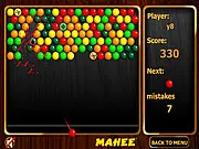 Screenshot of Mahee Bubbles Shooter online game showing a cannon aiming a colored marble at a cluster of matching bubbles on the game field