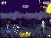 Skully's Quest game screenshot showing a cannon firing a flaming eyeball at gravestones and wooden structures in a cemetery setting, free online puzzle game