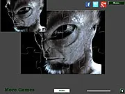 Real Alien Jigsaw puzzle free online game screenshot, scary green alien image, timed puzzle solving on PlayArcadeHub