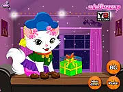 Screenshot of the My Little Kitty Birthday dress-up game showing a cute kitten wearing a fashionable outfit and accessories