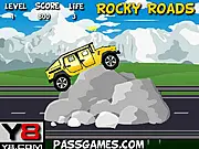 Rocky Roads game screenshot – a heavy-duty truck carefully balancing over a mountain of large boulders and rocks – free online truck game