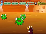 Gameplay screenshot of Ninja vs Aliens showing a small, masked ninja character attacking a green, cartoon-style alien enemy with a sword
