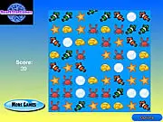 Screenshot of Fish Kingdom match 3 game showing colorful fish, bubbles, and shells being matched on a grid | Play free online summer puzzle game