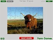 Highland Cow Jigsaw Puzzle game screen showing the finished image of a Highland Cow on a farm field
