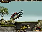 Play 4x4 ATV Offroad free online racing game screenshot; four-wheeler driving over a steep, hilly obstacle course