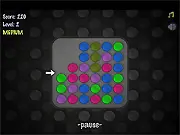 Gameplay screenshot of TumbleDots showing many colorful dots tumbling and being matched in a physics-based puzzle game