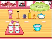 A close-up of a decorated Hello Kitty Apple and Banana Cupcake with pink frosting and a wafer topper in an online cooking game.