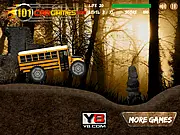 Monster Bus Driving free online game showing a large yellow monster school bus with huge tires driving through a dark, spooky forest.