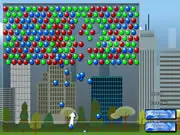 The Big City Bubble Shooter game screen showing a player aiming a colorful bubble cannon at a large cluster of bubbles descending over a cityscape background