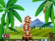 Gameplay screenshot of the free online game Monkeys Balance, showing several cartoon monkeys stacked on top of each other and a banana item in the foreground.