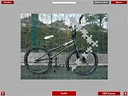 BMX Bike Jigsaw free online game screenshot showing scattered puzzle pieces of a bicycle