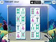 Screenshot of Deep Sea Mahjong showing a complex pyramid of tiles with an underwater background, featuring fish and treasure chest icons in a free online puzzle game