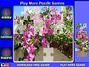 Bugenvilia Jigsaw game screenshot showing a partially completed puzzle of vibrant pink flowers, free online flower puzzle game