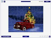 Screenshot of the Christmas Tree Delivery Jigsaw free online game showing puzzle pieces with a picture of a decorated Christmas tree on a truck