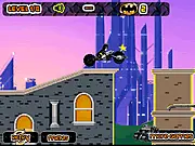 Lego Batman Racer game screenshot showing Lego Batman on a motorcycle on a rooftop in a brick-built Gotham City, collecting a glowing Bat-coin.