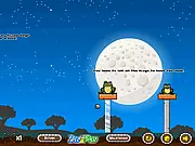 King Of The Swamp Slingshot Online game screenshot showing a slingshot aimed at a wooden structure with frogs on top