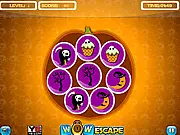 The game screen for Halloween Items Match Up, showing various Halloween objects like pumpkins and ghosts arranged on a dark background for players to find a matching pair