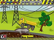 Monster Constructor 2 free online game screenshot showing a large construction truck carrying a heavy load of furniture driving across a bridge toward a warehouse after building a factory.