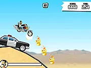 Stunt Guy: Tricky Rider 2D online game screenshot showing the biker on a dirt bike, mid-jump over a ramp on a desert-themed track