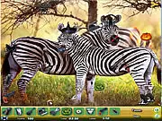 A close-up view of a dense, colorful zoo scene, showing various animals, objects, and a list of items to find, characteristic of a hidden object game.