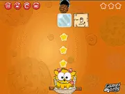The cookie dropping toward the smiling character Willy in the free online physics puzzle game Willy Likes Cookies