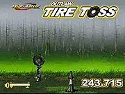 Tire Toss Challenge game screenshot showing a tire being thrown at two wooden stumps