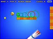 A cannon preparing to launch a ball in the Ballie Putt online physics puzzle game, aiming to hit other stationary balls