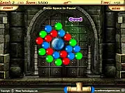 Gameplay screenshot of Color Blast, showing a central magnet surrounded by a cluster of multicolored, touching bubbles in a vibrant arcade match game.