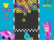 Tire Buster arcade game screen showing many colorful tires stacked up, with a player about to click a group to bust them.