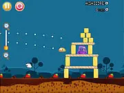Pudding Strike gameplay screenshot showing a slingshot launching a colorful pudding character toward a structure made of chocolate blocks and jelly drops, a free online physics puzzle game.