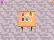 Donut Sort Puzzle online free game showing colorful stacked hoops being sorted onto different pegs