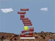 Detower physics stacking game screenshot, showing a tall, precarious tower structure built from blocks over a simple background