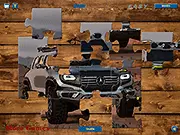 Screenshot of the Mercedes Off Road Jigsaw Puzzle online game in progress, showing several pieces of the powerful off-road vehicle already connected.
