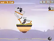 Screenshot of Slow and Blow Kings free online physics puzzle game, showing a complex wooden structure with strategically placed round bombs, a red bad guy, and a friendly blue good guy.