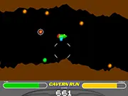 Screenshot of the Space Ace Cavern Run free online game, showing a small spaceship flying through a narrow, rocky cavern while collecting a glowing power-up.