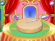 Screenshot of Baby Princesses Cake Cooking game showing a beautiful, decorated princess doll cake with pink frosting and colorful sprinkles