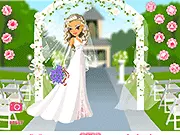 Gameplay screenshot of the Spring Wedding Dressup game, showing a bride character wearing a white wedding gown and veil, holding a flower bouquet.