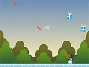 Screenshot of the Mr. Carrot Face game showing a character launching a carrot from his face into the air toward several falling gift presents in a free online arcade shooter.