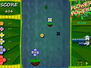 Gameplay screenshot of Flower Power Up, showing a small, colorful butterfly flying up the screen using flower platforms in a bright, sunny sky environment with oranges floating nearby.