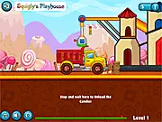 Screenshot of the Candy Land Transports online game showing a small red truck loaded with colorful candies racing over a steep green hill in a whimsical environment.