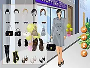 Screenshot of the Shopping Centre Dressup free online game showing a stylish model posing in a mall setting with different clothing options.