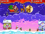 A chaotic scene from Holly Jolly Pyromaniac showing Santa's explosives destroying a green elf house while a purple house remains untouched. Play the free online Christmas game.