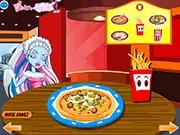 Decorating a pizza with various colorful ingredients in the Monster High Pizza Deco online game