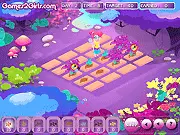 Screenshot of the Fairy Garden game showing a beautiful fairy, Misha, standing in a brightly colored garden with glowing flowers and tiny furniture.