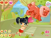 Gameplay screenshot of My Candy Zoo online game showing a colorful lollipop treat being decorated with chocolate and sprinkles, free decoration game