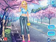 Spring Suits game screenshot showing a girl in a colorful new spring outfit standing next to beautiful pink cherry blossom trees. Play the free online dress-up game.